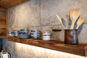 a shelf with blue and white bowls and utensils at Seehaus 96 Hallstatt in Hallstatt +37 photos