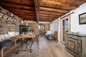a dining room with a table and a brick wall at Seehaus 96 Hallstatt in Hallstatt