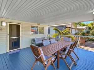 a wooden table and chairs on a deck at Magnetic Haven Unit 5 in Arcadia