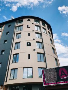 a tall building with the wordsania on it at Alibi Zlatibor in Zlatibor