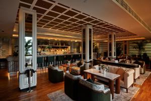 a restaurant with couches and tables and a bar at METT Singapore in Singapore