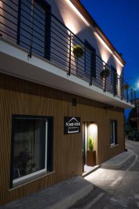 a building with a balcony and a sign on it at Fioretti Home in San Giorgio Montagna
