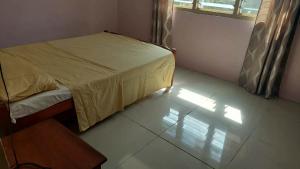 a small bedroom with a bed and a window at Vatudei Homestay - Yasawa Islands in Somosomo