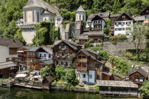 a group of houses on the side of a river at Seehaus 96 Hallstatt in Hallstatt