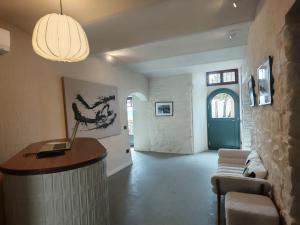 a living room with a lobby with a table and chairs at Erta Terra Hotel in Mazzolla