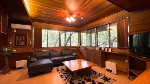 a living room with a couch and a table at Tabinoteitaku Zao Miyagi in Zao