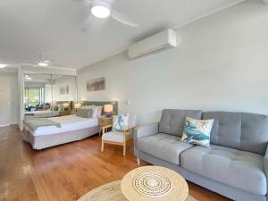 a living room with a couch and a table at Blue on Blue Studio Room 1222 in Nelly Bay