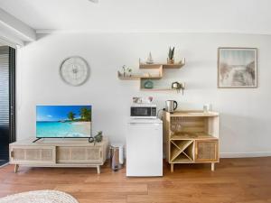 a kitchen with a white refrigerator and a microwave at Blue on Blue Studio Room 1222 in Nelly Bay