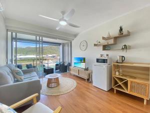 a living room with a couch and a table at Blue on Blue Studio Room 1222 in Nelly Bay