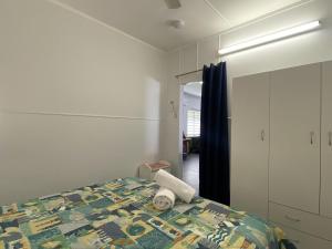 a bedroom with a bed with a towel on it at Whitehaven 2 in Picnic Bay +16 photos