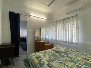 a bedroom with a bed and a sink and a mirror at Whitehaven 2 in Picnic Bay