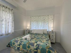 a bedroom with a bed with a colorful quilt at Whitehaven 2 in Picnic Bay