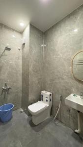 a bathroom with a toilet and a sink at Vortex Suites in Guwahati
