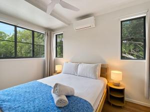 a bedroom with a bed and two windows at Picnic Point in Picnic Bay +34 photos