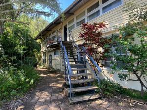 a house with a blue staircase leading up to a house at The Captains Manor On Cook 5 in Arcadia +4 photos
