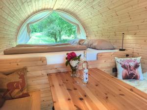 a room with a bed and a table with a window at Übernachtungsfaß in Alpirsbach