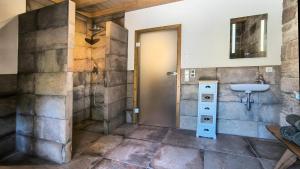 a bathroom with a sink and a door at Übernachtungsfaß in Alpirsbach
