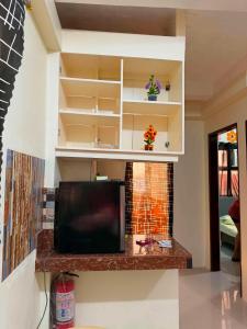 a living room with a tv and a fireplace at DC Travellers Inn Unit E 3rd Fl in Malolos