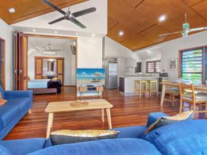 a living room with a blue couch and a table at Pure Magnetic Villa 4 in Nelly Bay