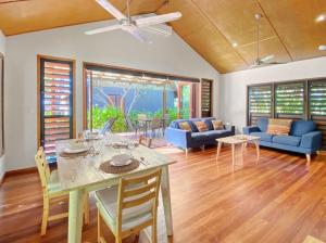 a living room with a table and chairs at Pure Magnetic Villa 4 in Nelly Bay +21 photos