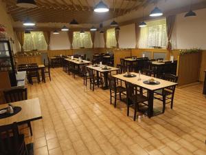 a restaurant with tables and chairs in a room at Hostinec U Havlů in Olomouc