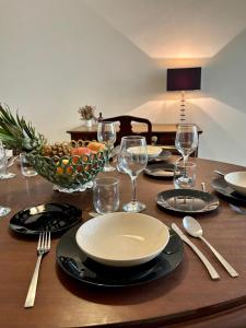 a table with plates and glasses and a bowl of fruit at 166, Rodolfu in Sliema