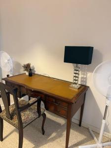 a desk with a lamp and a chair at 166, Rodolfu in Sliema