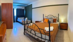 a bedroom with two beds with orange pillows at 166, Rodolfu in Sliema