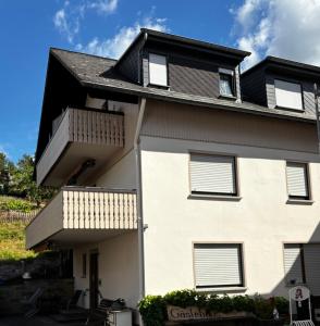 a house with two balconies and a black roof at Gästehaus Neier in Boppard