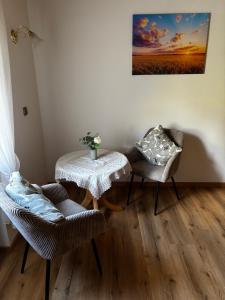 a room with a table and two chairs and a table with at Gästehaus Neier in Boppard