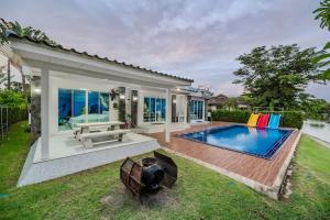 a backyard with a swimming pool and a house at Shark House - Pool Villa RB13 in Ban Klam +107 photos