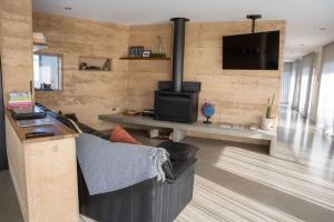 a living room with a couch and a fireplace at The Well - Peterborough in Peterborough
