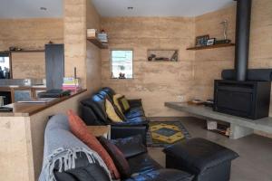 a living room with a couch and a stove at The Well - Peterborough in Peterborough