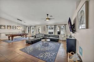 a living room with a couch and a pool table at Ultimate Vacation: A Luxurious Oasis with a Pool! in Las Vegas