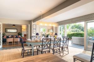 a dining room and living room with a table and chairs at Finest Retreats - The Old Schoolhouse at Penrhos in Raglan