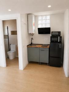 a small kitchen with a sink and a stove at Luz y calma junto al mar in Lagos