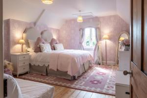 a bedroom with a large bed with a large mirror at Finest Retreats - The Old Schoolhouse at Penrhos in Raglan +40 photos