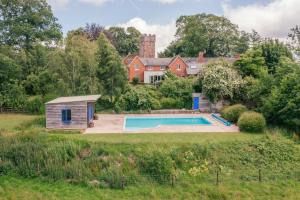 a house with a swimming pool in a yard at Finest Retreats - The Old Schoolhouse at Penrhos in Raglan