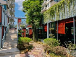 an external view of a building with a tree at Trival Property Homestay Sri Indah Sandakan in Sandakan