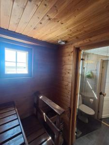 a bathroom with a toilet and a glass shower at Yyterin Villa Pyrylä in Yyteri +26 photos