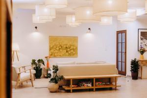 a living room with a bed and a painting on the wall at Luna in Kazimierz Dolny