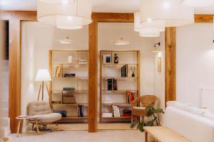 a living room with white walls and wooden beams at Luna in Kazimierz Dolny +52 photos