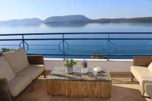 a living room with a view of the water at Grand Bleu Apartments & Villas in Ermioni