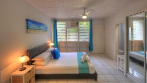 a bedroom with a large bed and two windows at Loyang Apartment 2 in Arcadia
