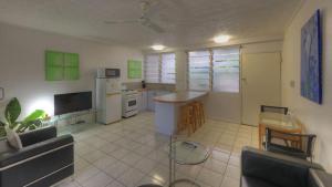 a living room with a couch and a kitchen at Loyang Apartment 2 in Arcadia