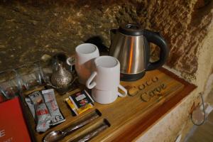 a counter with a coffee pot and cups on it at Coco Cave in Göreme