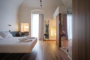a bedroom with a bed with towels on it at Benedamò Home Inside in Polignano a Mare