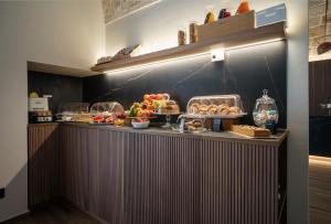 a buffet with fruits and vegetables on a counter at Benedamò Home Inside in Polignano a Mare