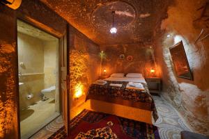 a bedroom with a bed and a bathroom with a shower at Coco Cave in Göreme +106 photos
