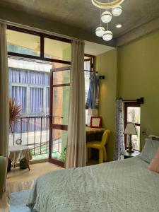 a bedroom with a bed and a window with a view at Tiny bright house Autum space in Danang